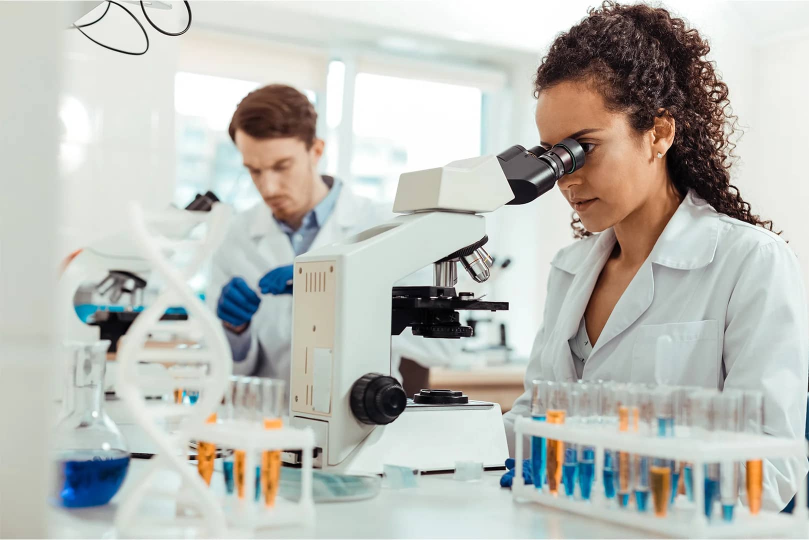 smart-female-biologist-looking-into-the-microscope-by-viacheslav-yakochuk-from-adobe-stock