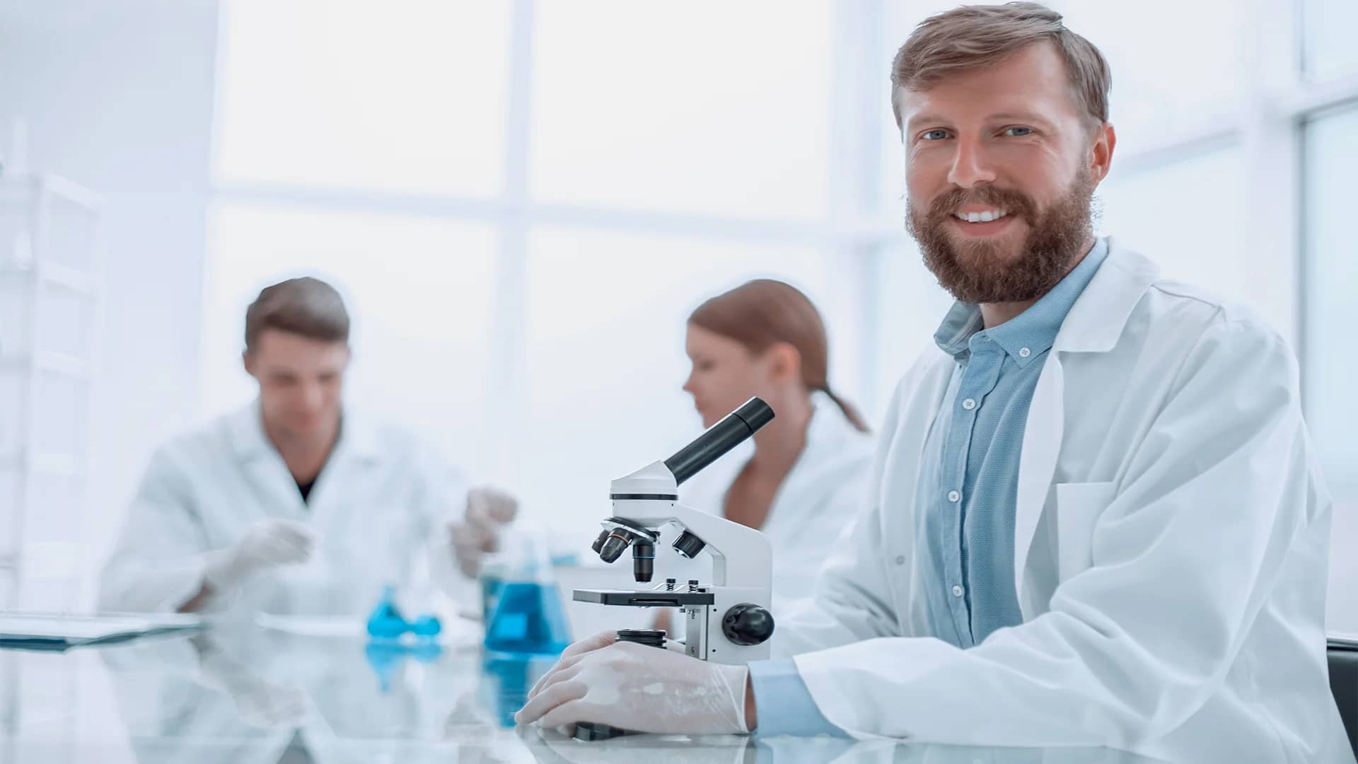 a-successful-young-scientist-sitting-at-his-desk-by-asdf-from-adobe-stock