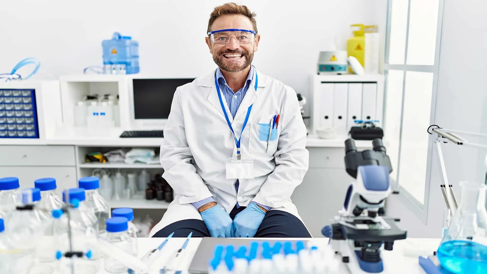 middle-age-man-working-at-scientist-laboratory-looking-positive-by-krakenimages-from-adobe-stock